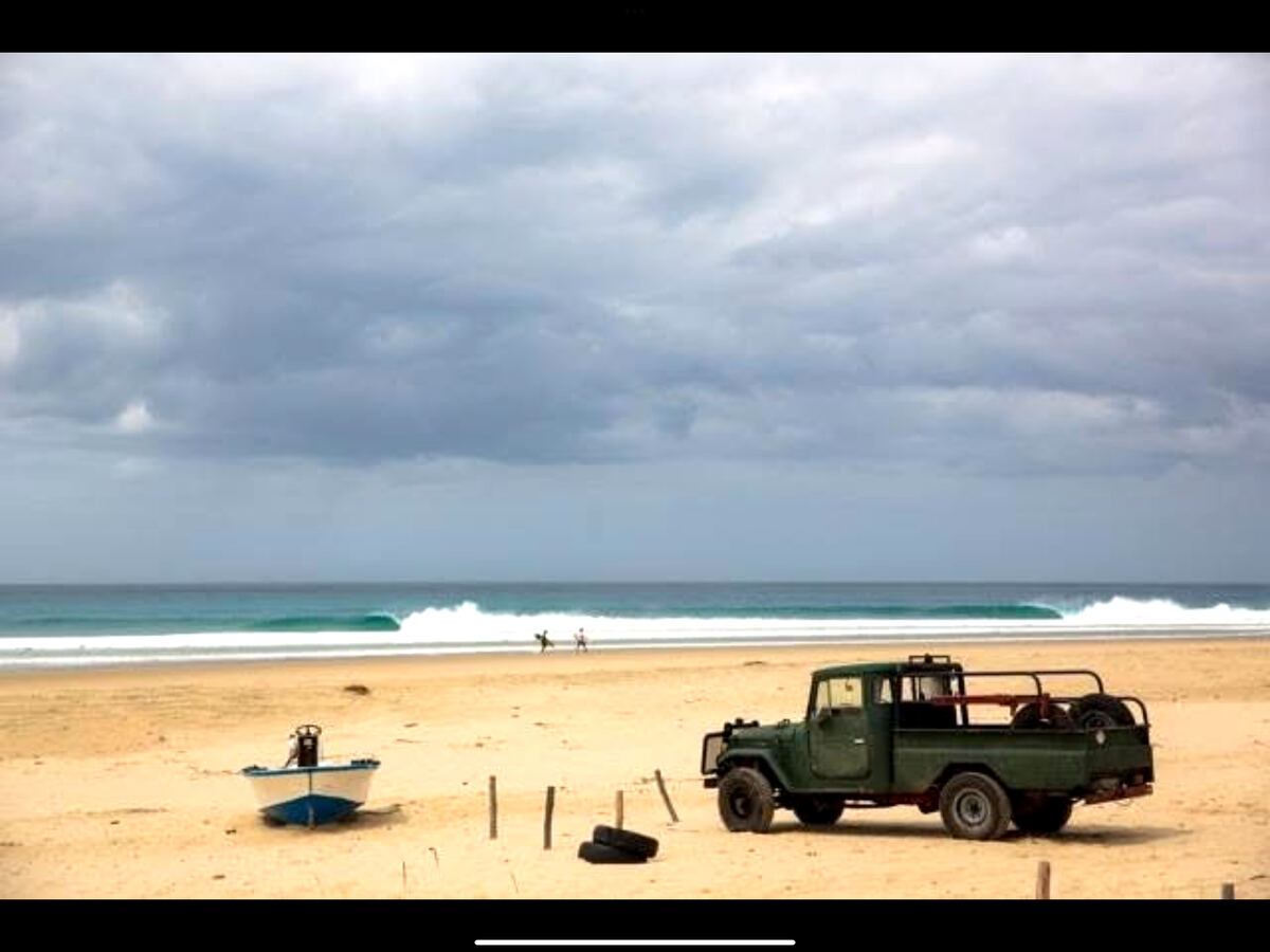 Mozambique beach with a Land Cruiser on the sand
